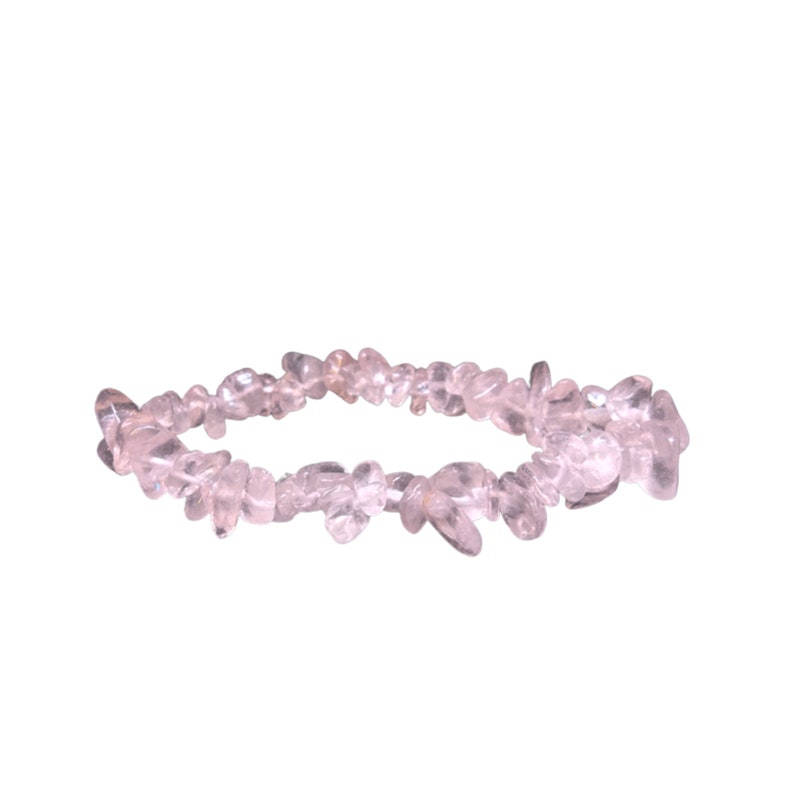 May include: A delicate bracelet made of small, clear, pink quartz chips. The bracelet is strung on elastic and is designed to fit most wrists.