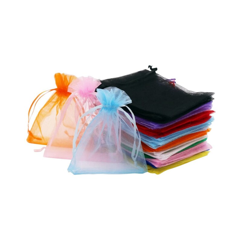 May include: A stack of colorful organza gift bags in various colors, including black, purple, red, orange, yellow, light blue, and pink. The bags are made of sheer fabric and have a drawstring closure.