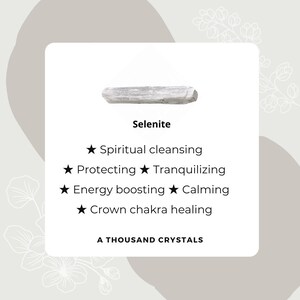 May include: A white selenite crystal, a type of mineral known for its calming and cleansing properties. The text on the image reads "Selenite", "Spiritual cleansing", "Protecting", "Tranquilizing", "Energy boosting", "Calming", "Crown chakra healing", and "A Thousand Crystals".