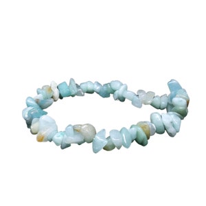 May include: A light blue aquamarine chip bracelet made of natural stones. The bracelet is made of small, irregular shaped chips of aquamarine.