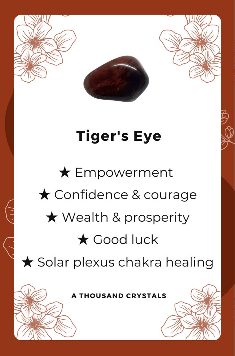 May include: A brown and gold tiger's eye crystal with a smooth, polished surface. The crystal is associated with empowerment, confidence, courage, wealth, prosperity, good luck, and solar plexus chakra healing. The text "Tiger's Eye" and "A Thousand Crystals" is also visible in the image.