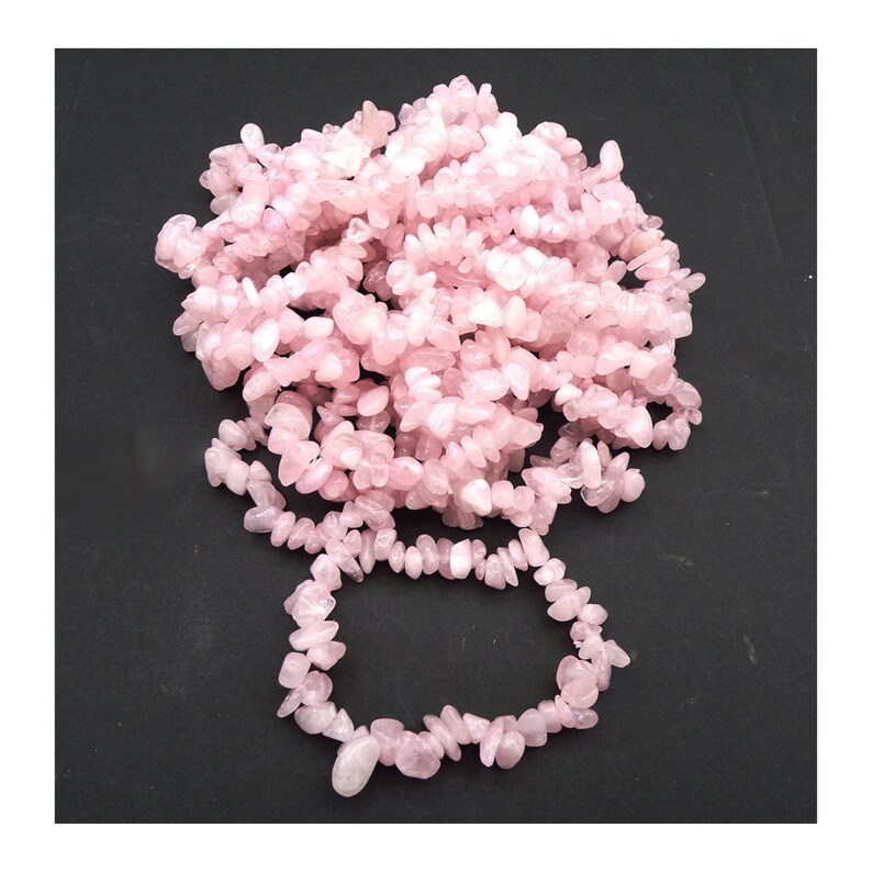 May include: A strand of pink rose quartz chip beads, with a smaller strand of the same beads forming a bracelet.