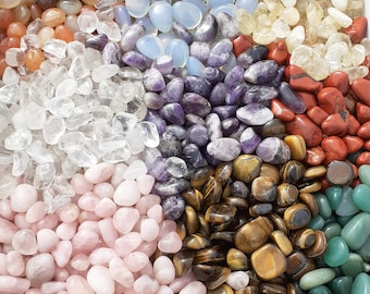 May include: Assortment of tumbled stones in various colors and shapes, including clear quartz, amethyst, rose quartz, tiger's eye, and red jasper.