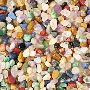 May include: A collection of colourful, smooth, polished stones in various shapes and sizes. The stones are a mix of natural and tumbled stones, and they are perfect for crafting, decorating, or adding a touch of nature to your home.