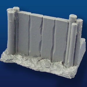 May include: A gray plastic miniature model of a wooden fence with a textured surface. The fence is made of planks and posts.