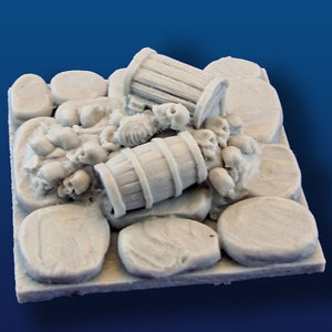 May include: A miniature scene of a pile of skulls and bones with two overturned wooden barrels on a stone surface.