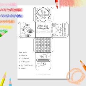 May include: A printable coloring page for a Ramadan Sadaka Box. The box is shaped like a cube and has six sides. Each side has a different design, including a mosque, lanterns, and stars. The text on the box says "My Sadaka Box" and "This box belongs to". The instructions for using the box are listed below the box.