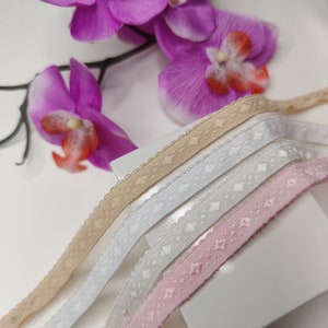 9-18 mm pre-folded elastic. Bound elastic, patterned elastic with picot edge. FOE in white, off-white, beige, and pink. IDelx19