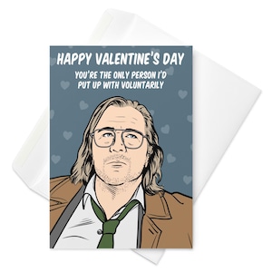 Puede incluir: Tarjeta de San Valentín con una ilustración de dibujos animados de un hombre con gafas y corbata verde. La tarjeta dice "Happy Valentine's Day, You're the only person I'd put up with voluntarily" sobre un fondo azul.