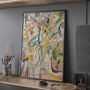 May include: Abstract painting in a black frame with yellow, green, white, and pink colors. The painting is of a tree with branches and leaves.