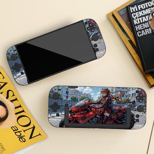May include: Two black handheld gaming consoles with custom skins. One skin features a cityscape design, the other a red motorcycle with a character. The consoles have black buttons and a black screen.