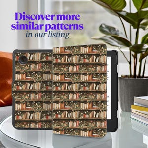 May include: A black and brown Kindle e-reader case with a floral bookshelf pattern. The case has a flap that covers the screen.