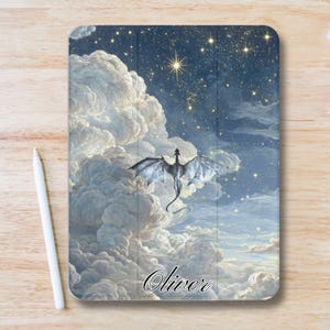 May include: A tablet case featuring a fantasy scene with a dragon soaring through clouds under a starry night sky. The dragon is gray with outstretched wings. The name "Oliver" is written in cursive at the bottom.