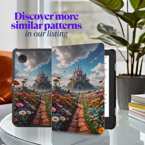 May include: A black tablet case and e-reader with a vibrant fantasy landscape design. The design shows a path leading to a castle on a hill, surrounded by flowers. Text in the image reads: Discover more similar patterns in our listing.