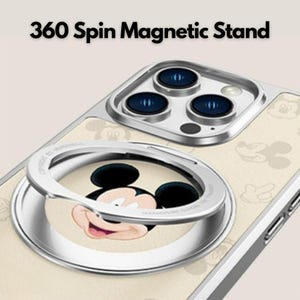 K&ouml;nnte beinhalten: Handyh&uuml;lle mit silbernem Magnetst&auml;nder und Mickey Mouse-Design. Die H&uuml;lle hat einen cremefarbenen Hintergrund mit Mickey Mouse-Silhouetten. Der Text "360 Spin Magnetic Stand" steht oben.
