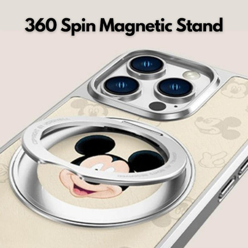 K&ouml;nnte beinhalten: Handyh&uuml;lle mit silbernem Magnetst&auml;nder und Mickey Mouse-Design. Die H&uuml;lle hat einen cremefarbenen Hintergrund mit Mickey Mouse-Silhouetten. Der Text "360 Spin Magnetic Stand" steht oben.