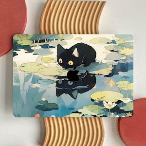 May include: Laptop case with a black cat illustration. The design depicts a black cat on lily pads in a pond with reflections. The case has a glossy finish and is designed to fit a laptop.