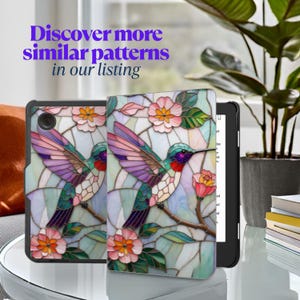 May include: A black tablet case with a colorful stained-glass design featuring a hummingbird and flowers. The case is open, revealing the tablet screen. The text "Discover more similar patterns in our listing" is displayed in purple.