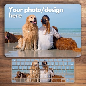 May include: A keyboard skin with a beach scene featuring a woman and several golden retrievers. The keyboard skin has a blue background and white keys with black lettering. The text "Your photo/design here" is at the top of the image.