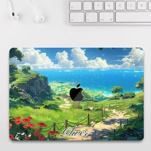 May include: A laptop skin depicting a coastal landscape with a path to the sea under a blue sky with clouds. The design includes a black apple logo and the name "Oliver" in cursive.