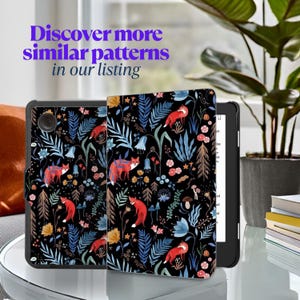 May include: A black Kindle Paperwhite e-reader with a floral and fox print case. The case has a black background with blue, red, and green flowers and foxes.