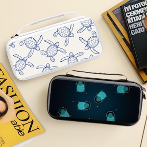 May include: Two rectangular cases with handles. One is white with blue turtle illustrations. The other is black with a space-themed turtle design. Both cases have a zipper closure and a white handle.
