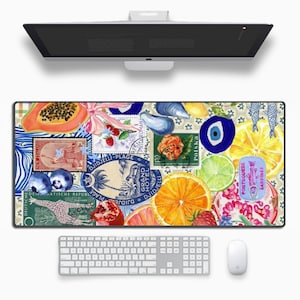 May include: A colourful mouse mat featuring a collage of images including fruit, flowers, stamps, and a blue evil eye. The mouse mat has a white background with a repeating pattern of small blue and white flowers.