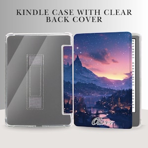 May include: Clear Kindle case with a clear back cover. The case is open, revealing the Kindle's screen. The cover features a scenic illustration of a mountain range, lake, and town under a starry sky. The name "Oliver" is printed on the cover.