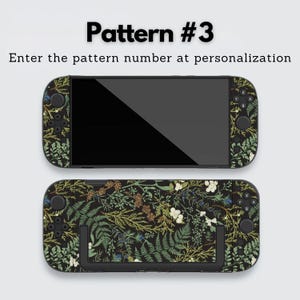 May include: Two black handheld gaming console skins with a botanical pattern featuring green ferns, white flowers, and brown accents. The text "Pattern #3" and "Enter the pattern number at personalization" are displayed at the top.