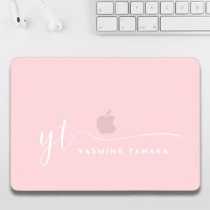 May include: Pink laptop skin with a white apple logo and the text "yt YASMINE TANAKA" in a cursive font.