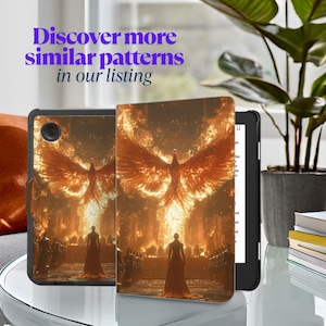 May include: A black Kindle e-reader with a protective case featuring a fiery phoenix rising from a golden city. The case has a textured, leather-like finish.
