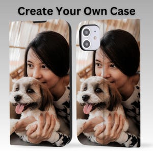 May include: Phone case featuring a photo of a woman holding a small dog. The dog has brown and white fur and its tongue is sticking out. The phone case has the text "Create Your Own Case" at the top.