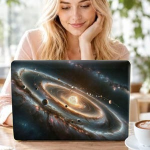 May include: A laptop skin featuring a detailed space illustration of a solar system with a central glowing star, multiple orbiting planets of varying sizes, and concentric orbital rings set against a dark, swirling nebula background.