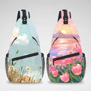 May include: Two sling backpacks with different designs. One backpack has a blue sky with white clouds and flowers. The other backpack has a pink sunset over a body of water with pink tulips.