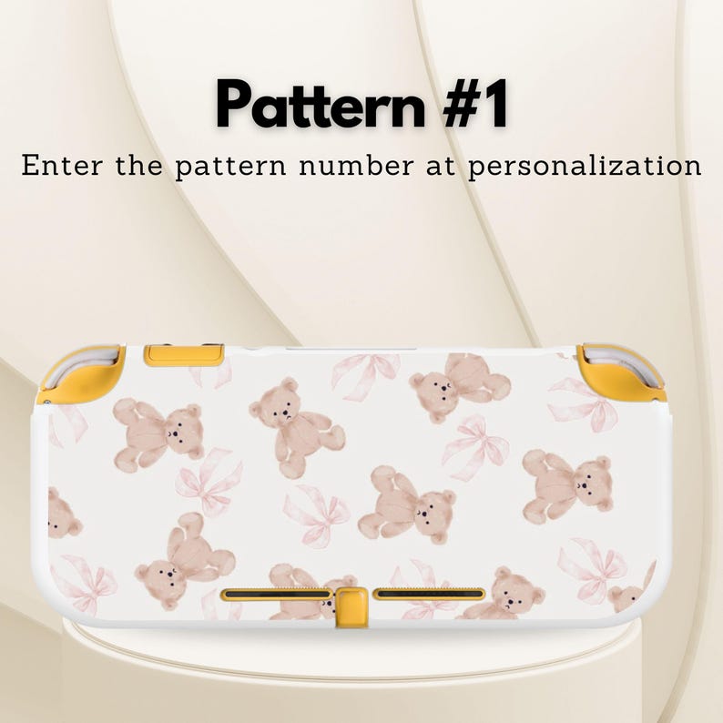 May include: White and yellow Nintendo Switch Lite case with a pattern of tan teddy bears and pink bows. The text "Pattern #1" and "Enter the pattern number at personalization" are displayed on the top of the image.