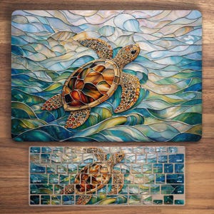 May include: A laptop skin and keyboard cover with a sea turtle design. The turtle has a brown and orange shell, with a detailed pattern. The background is a mosaic of blue, green, and white waves. The keyboard cover has a matching design.