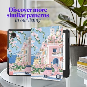 May include: A black tablet case and cover with a colorful illustration of a coastal town with pink buildings, flowers, and a pink scooter. The text "Discover more similar patterns in our listing" is displayed in purple.