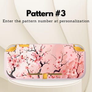 May include: A pink and white patterned Nintendo Switch Lite case featuring a floral design with cherry blossoms. The case has yellow accents and the text "Pattern #3" and "Enter the pattern number at personalization".