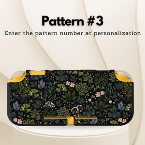 May include: A black and yellow patterned case for a handheld gaming device. The case features a floral design with green leaves, pink flowers, and white accents. The text "Pattern #3" and "Enter the pattern number at personalization" are displayed.