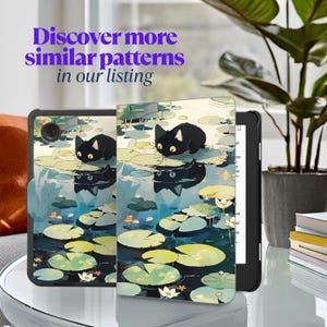 May include: A black e-reader case featuring a whimsical illustration of a black cat on a pond with lily pads. The text "Discover more similar patterns in our listing" is displayed in purple.