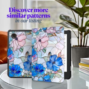May include: A black e-reader with a floral pattern cover featuring pink and blue flowers. The cover design resembles stained glass. The text "Discover more similar patterns in our listing" is visible.