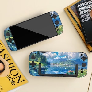 May include: Two Nintendo Switch consoles with landscape-themed skins. One console is open, displaying a black screen, while the other is in a dock. The skins feature a mountain, lake, and floral design with blue, green, and white colors.