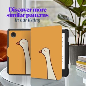 May include: A tablet case with a whimsical goose design. The case is orange with a white goose illustration. The text "Discover more similar patterns in our listing" is in purple. The tablet is black.