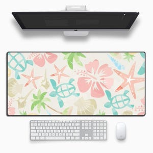May include: A colourful desk mat with a tropical theme. The design features pink hibiscus flowers, green palm leaves, blue sea turtles, and orange starfish on a white background.