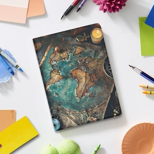 May include: A journal with a vintage world map design. The cover features a detailed map in shades of brown and teal, with a compass and a lit candle. Pens, crayons, and other stationery items surround the journal.