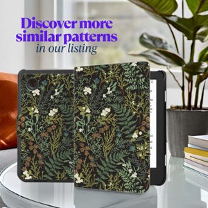 May include: A black e-reader with a floral patterned case. The case features a dark background with green, white, and brown floral designs.