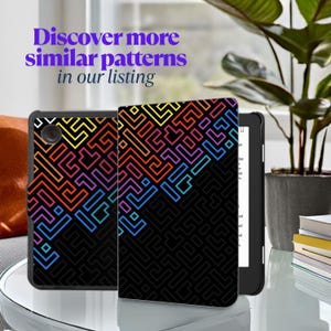May include: Black e-reader case with a colorful geometric pattern in yellow, orange, pink, purple, and blue. The text "Discover more similar patterns in our listing" is in purple. The e-reader is open, displaying a white screen.