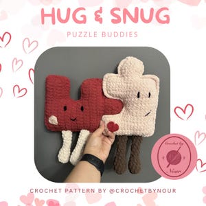 May include: Two crocheted puzzle piece plushies, one red and one pink, with smiling faces and heart details. The plushies are holding hands and have brown legs. The text "HUG & SNUG PUZZLE BUDDIES" is at the top of the image. The text "Crochet by Nour" is in a circle at the bottom right of the image.