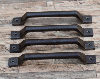 May include: Four dark brown metal handles with a textured finish. Each handle has a rectangular base with a single hole for mounting. The handles are evenly spaced and arranged horizontally. The handles are likely for furniture.