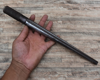 May include: A long, thin, metal tool with a black rubber handle. The tool has a groove running down the length of it.